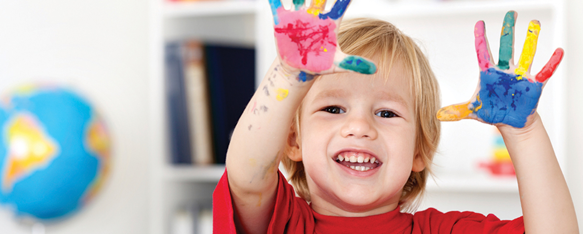 A preschooler painting at the art table